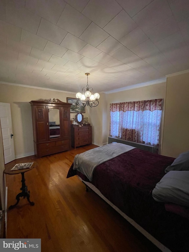 bedroom featuring a notable chandelier, wood-type flooring, crown molding, and radiator