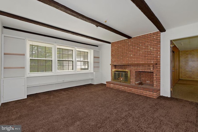 unfurnished living room featuring beam ceiling, a fireplace, and dark colored carpet