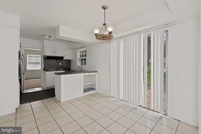 kitchen featuring white cabinetry, a wealth of natural light, and tasteful backsplash