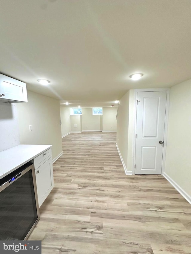 interior space featuring beverage cooler and light wood-type flooring