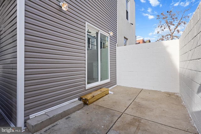 view of side of home featuring a patio