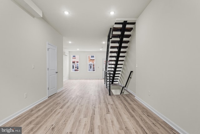 corridor with light hardwood / wood-style flooring