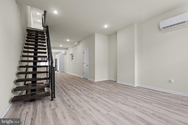 interior space with an AC wall unit and light wood-type flooring