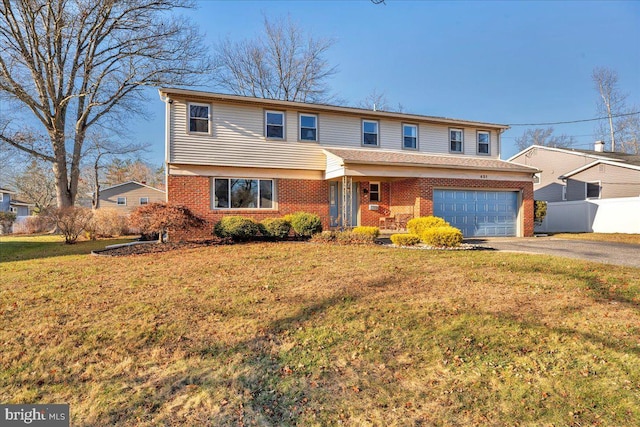 view of property featuring a front yard and a garage