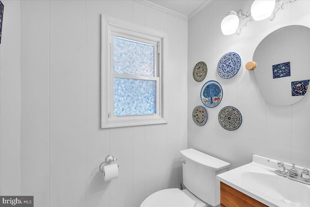 bathroom featuring crown molding, vanity, and toilet