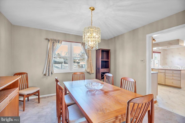 carpeted dining space featuring a notable chandelier