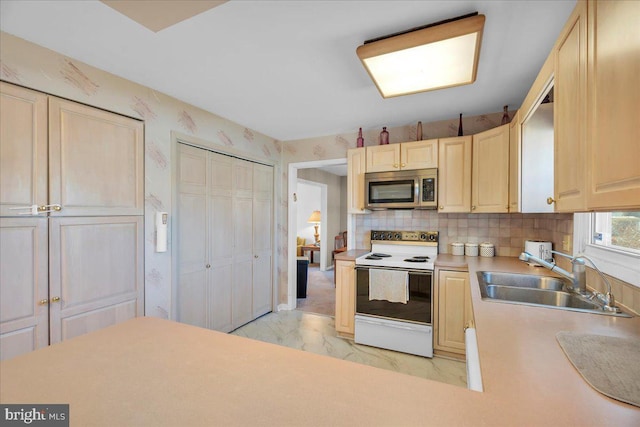 kitchen with decorative backsplash, sink, and white electric range