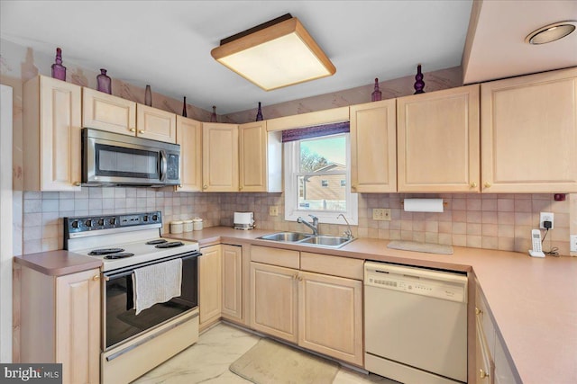 kitchen featuring backsplash, white appliances, and sink