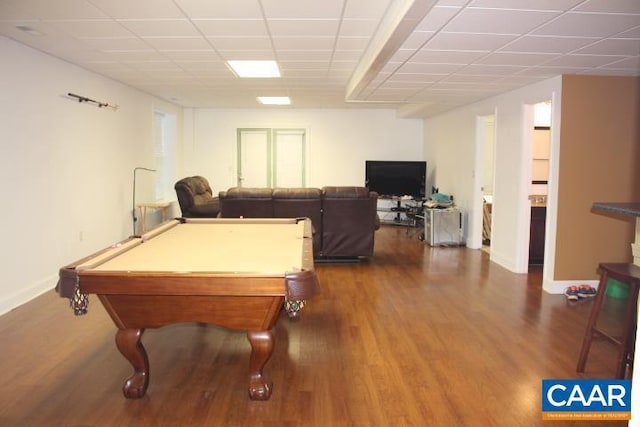 recreation room with a paneled ceiling, dark hardwood / wood-style flooring, and billiards