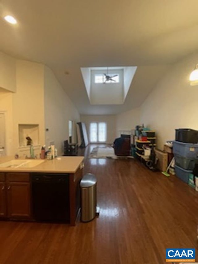 kitchen with sink, dark hardwood / wood-style flooring, lofted ceiling, and black dishwasher