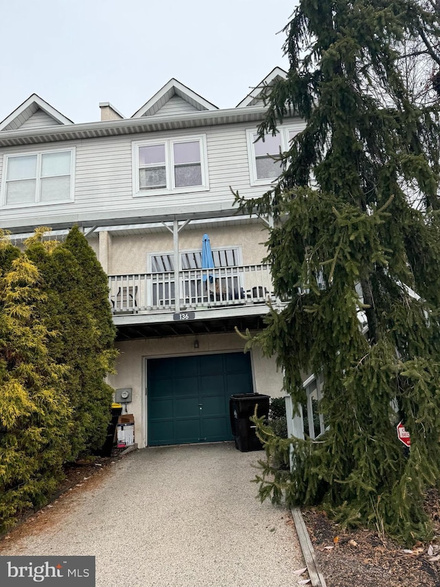 view of front of home with a balcony and a garage