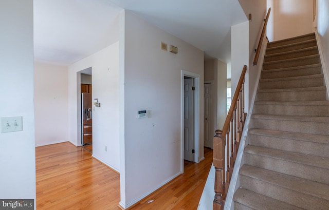 stairway featuring hardwood / wood-style flooring