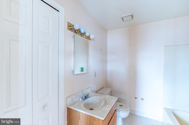 bathroom featuring tile patterned flooring, vanity, and toilet