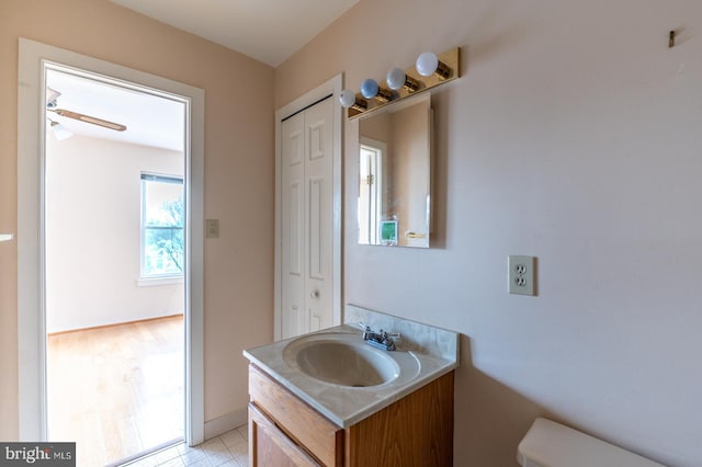 bathroom featuring ceiling fan, vanity, and toilet