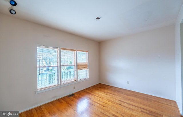 empty room with light hardwood / wood-style floors