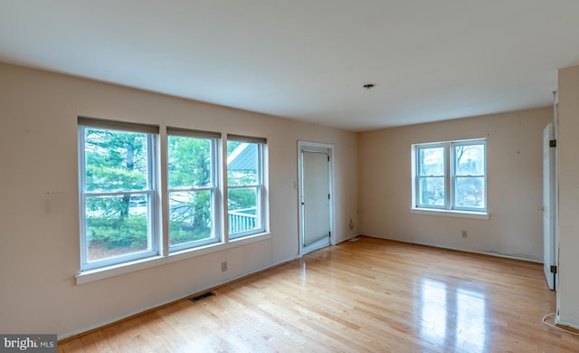 unfurnished room with a wealth of natural light and light wood-type flooring