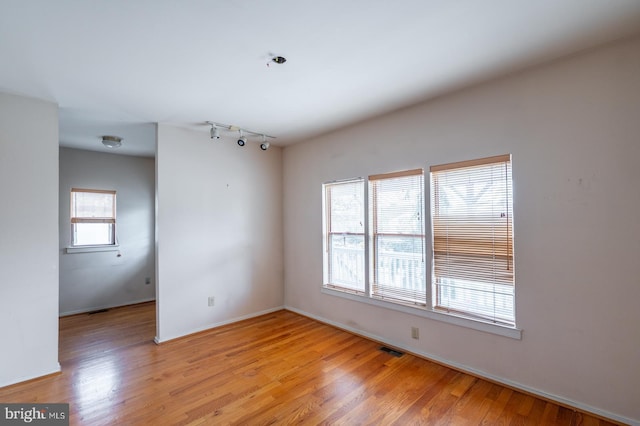 unfurnished room with light hardwood / wood-style flooring