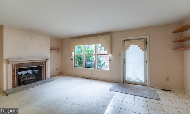 unfurnished living room with a fireplace and light tile patterned flooring