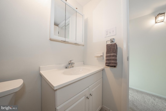 bathroom featuring vanity and toilet