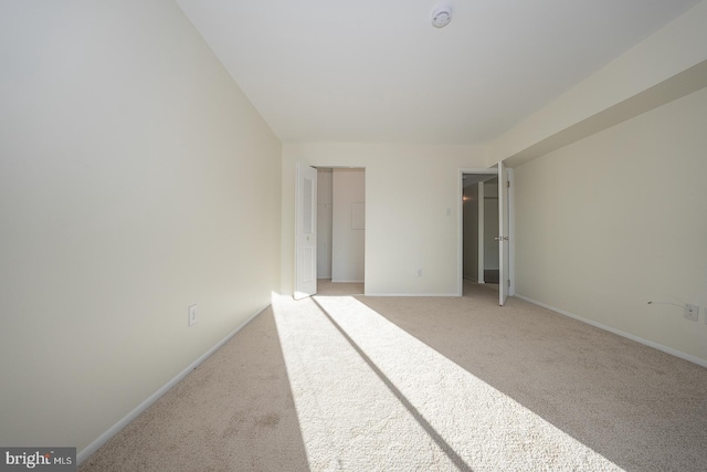 unfurnished bedroom featuring light carpet