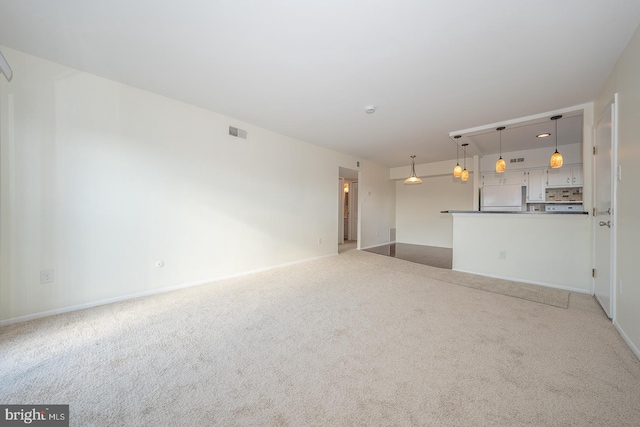 unfurnished living room with light colored carpet