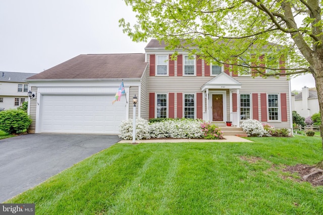 view of front facade with a garage and a front yard