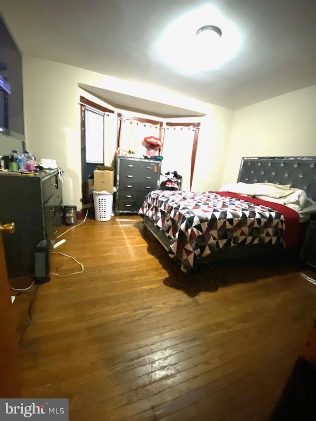 bedroom with hardwood / wood-style flooring