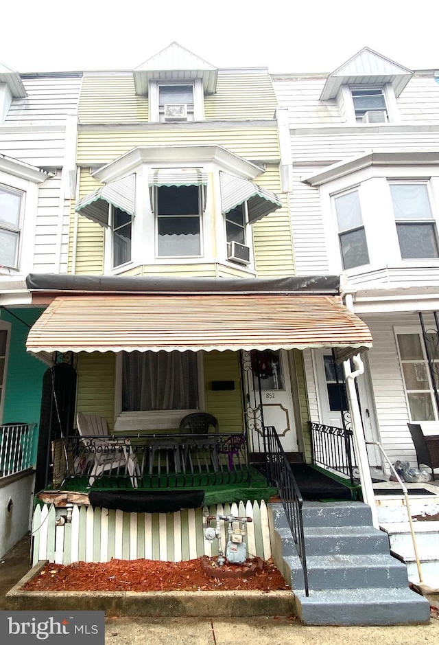 view of property featuring cooling unit and covered porch