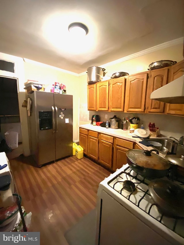 kitchen with white gas range, crown molding, stainless steel fridge with ice dispenser, and dark wood-type flooring