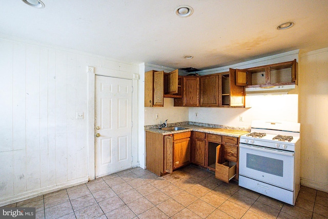 kitchen featuring ventilation hood, light tile patterned floors, sink, and gas range gas stove