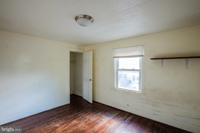 unfurnished bedroom with dark hardwood / wood-style flooring