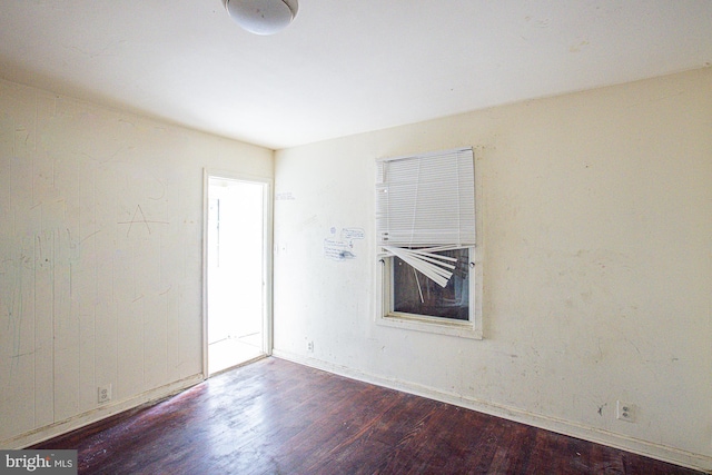 empty room with hardwood / wood-style flooring