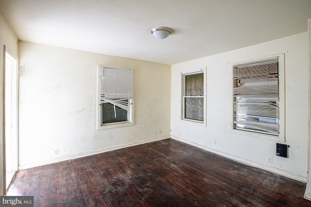 empty room featuring dark hardwood / wood-style flooring