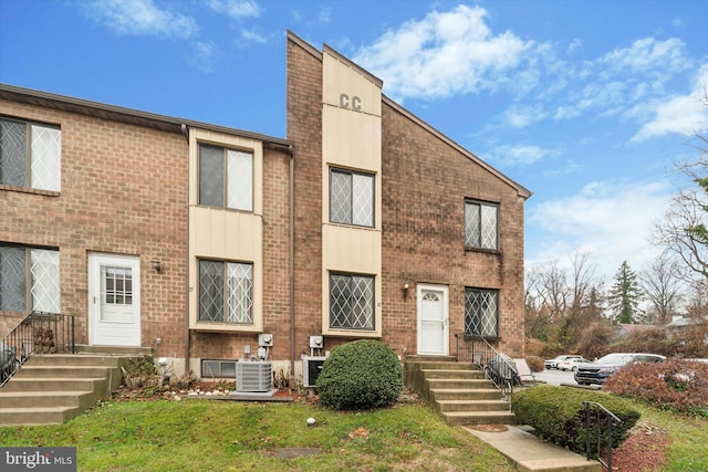 exterior space featuring a front lawn and cooling unit