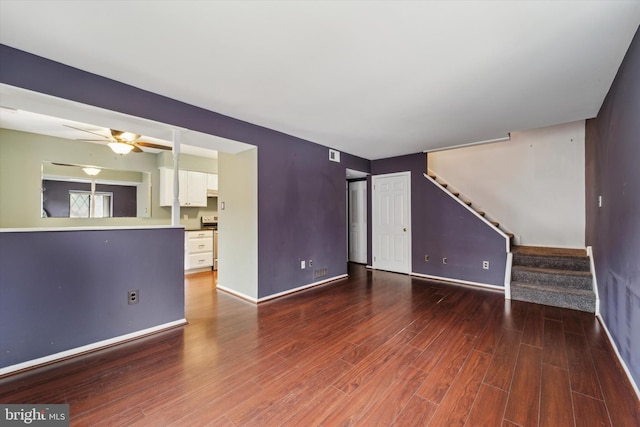 unfurnished living room featuring ceiling fan and dark hardwood / wood-style floors