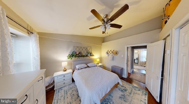 bedroom with lofted ceiling, ceiling fan, and dark wood-type flooring