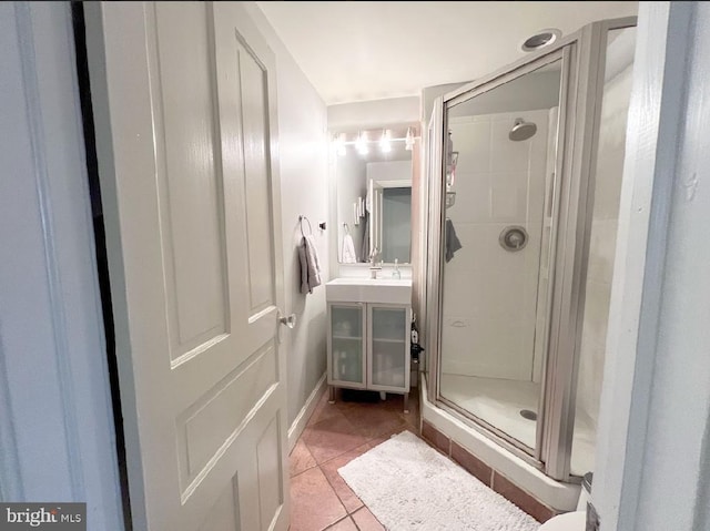 bathroom featuring tile patterned flooring and a shower with shower door