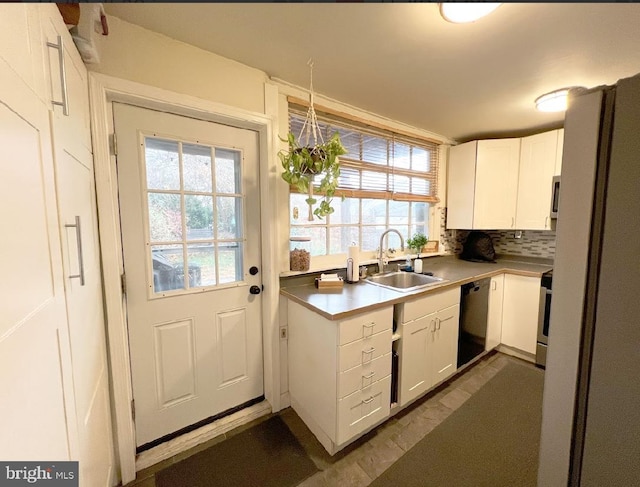 kitchen featuring white cabinetry, dishwasher, sink, backsplash, and stainless steel range with electric cooktop