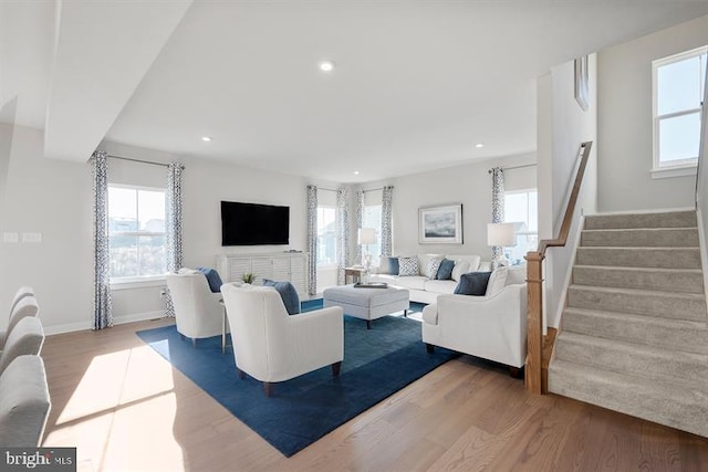 living room with hardwood / wood-style floors, plenty of natural light, and a fireplace