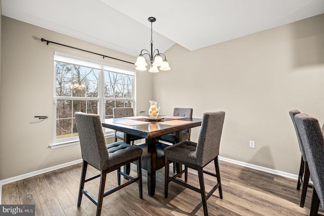 dining space featuring a notable chandelier and hardwood / wood-style flooring