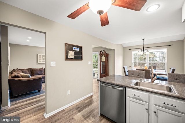 kitchen with white cabinetry, dishwasher, sink, hanging light fixtures, and hardwood / wood-style floors