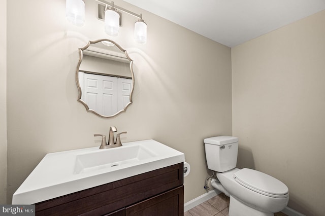 bathroom with tile patterned floors, vanity, and toilet