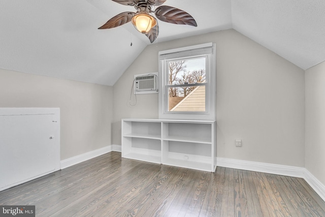 bonus room with ceiling fan, hardwood / wood-style floors, a wall mounted AC, a textured ceiling, and vaulted ceiling