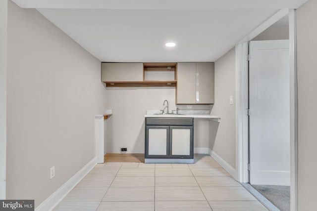 kitchen featuring sink and light tile patterned flooring