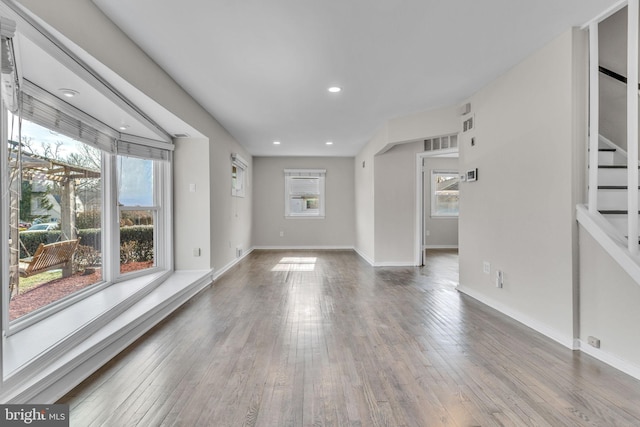 unfurnished living room with hardwood / wood-style flooring