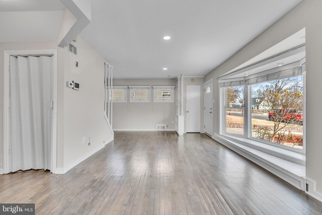 unfurnished living room featuring hardwood / wood-style floors