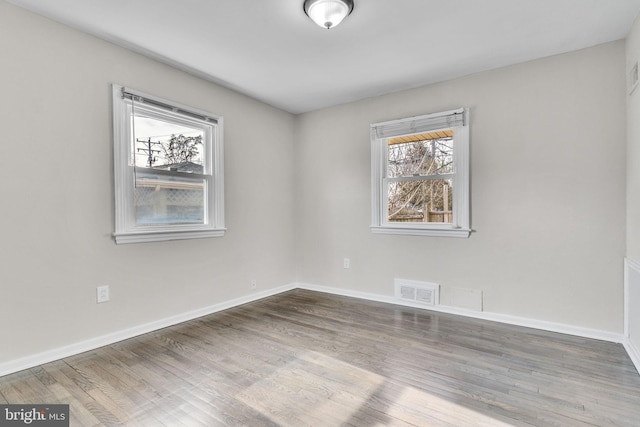 unfurnished room featuring hardwood / wood-style flooring