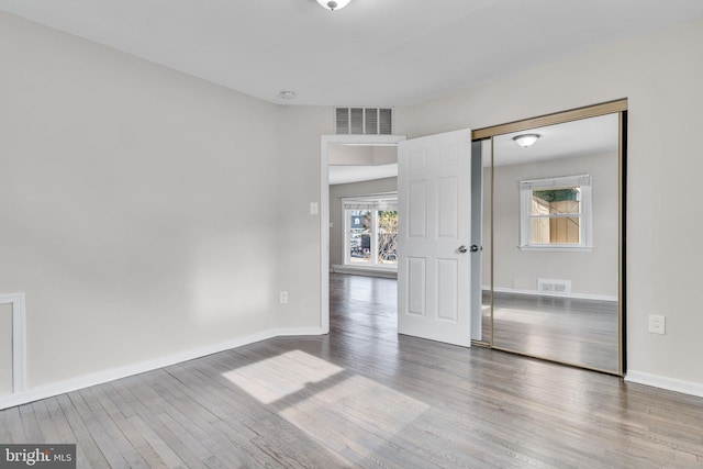 spare room with hardwood / wood-style flooring