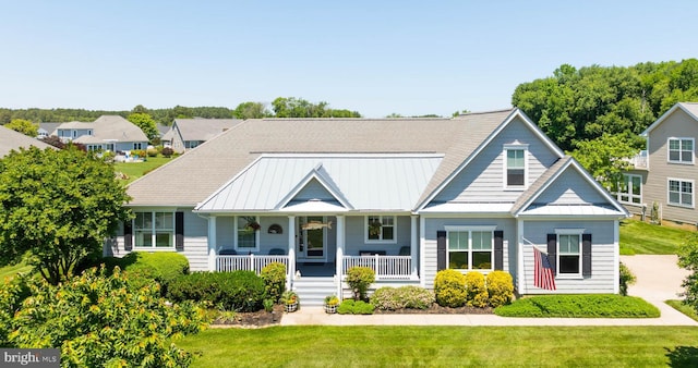 view of front of house with a porch and a front yard