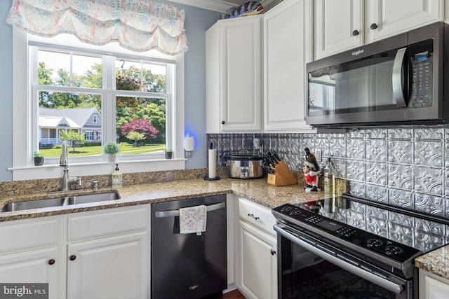 kitchen with stainless steel dishwasher, black electric range oven, sink, and white cabinets